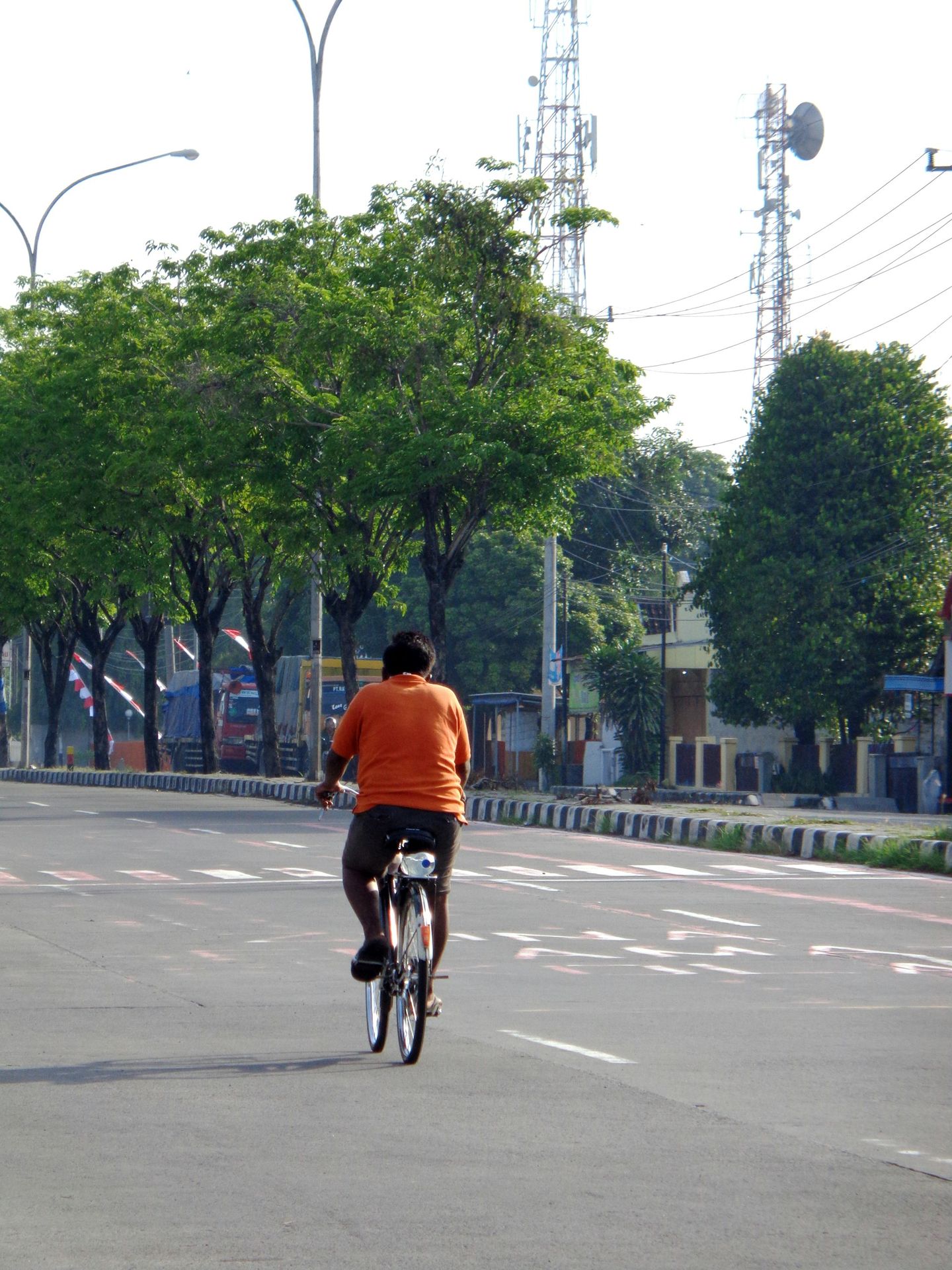 a man riding a bike down the middle of a street